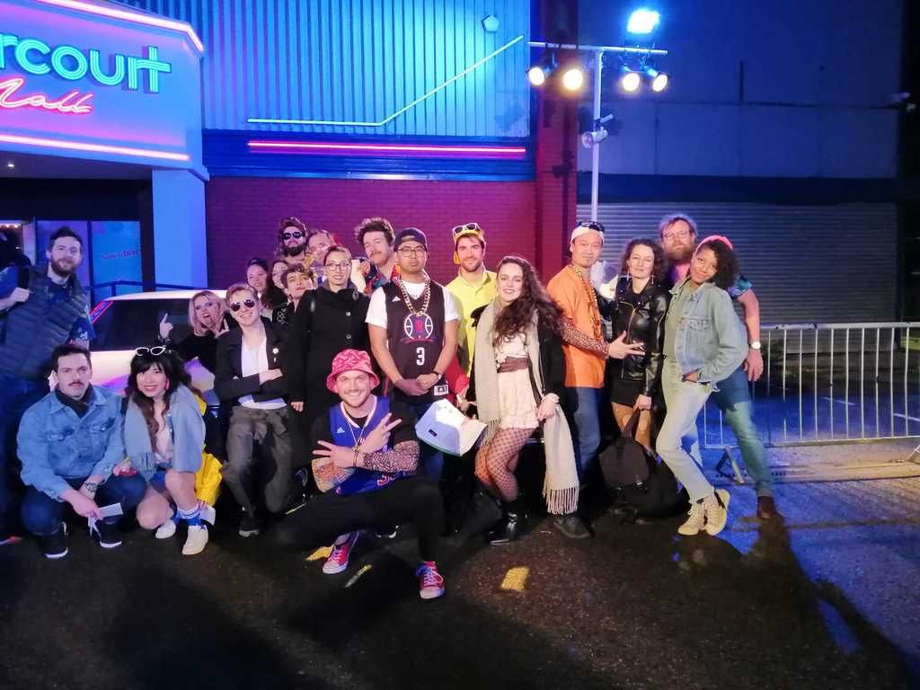 Group photo at Stranger Things Secret Cinema, in front of "Starcourt Mall"