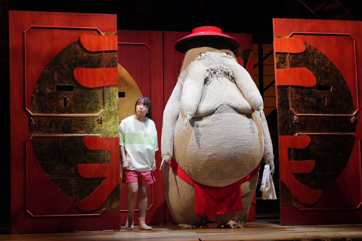 Picture of the Spirited Away theatre production showing the bath house elevator scene where an actress playing Chihiro is sta