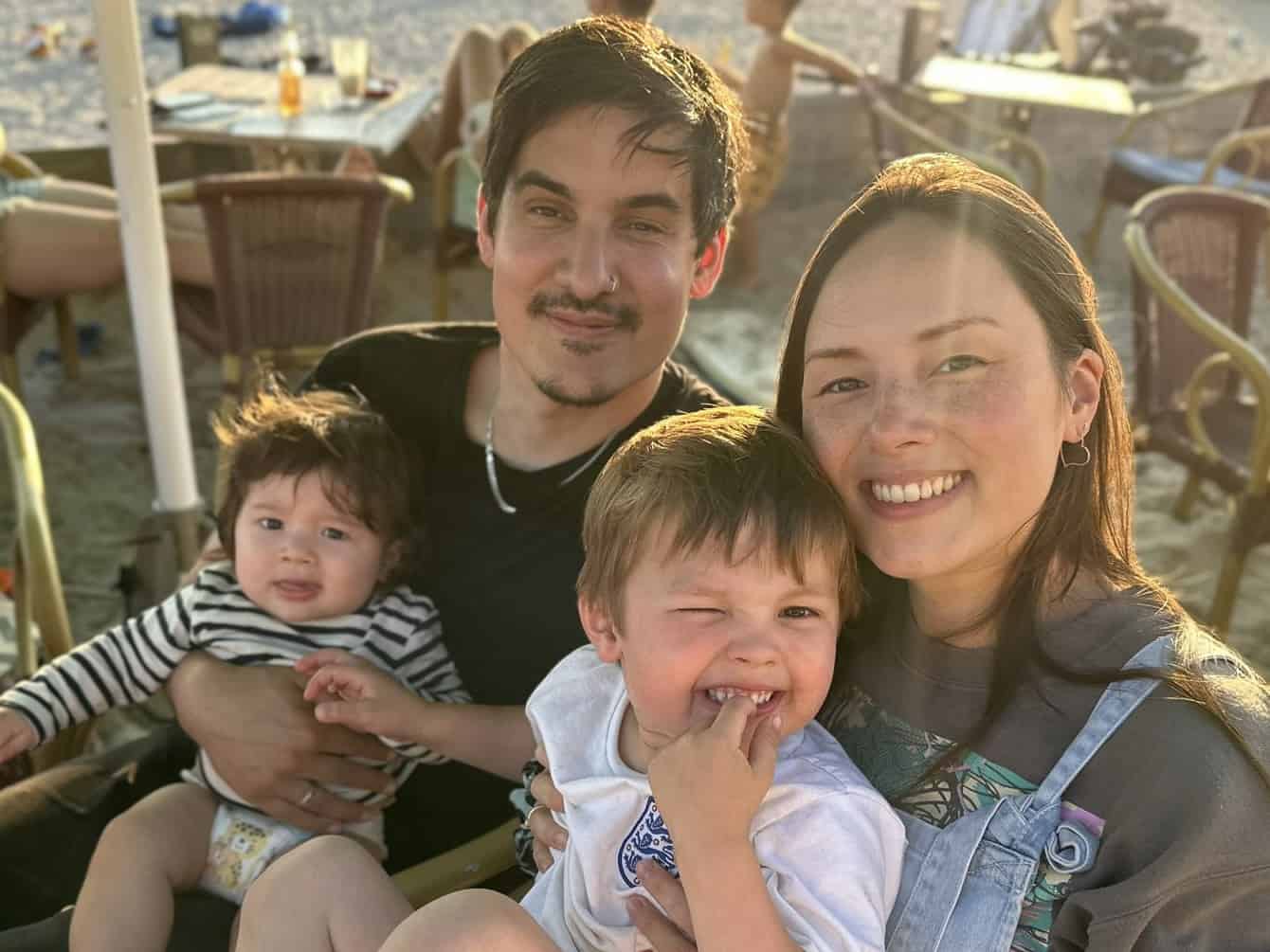 Family photo of Xandra, her partner Jay and their 2 little kids at the beach